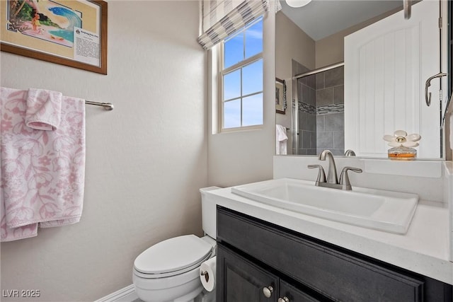4220 San Alivia Ct, Las Vegas, NV 89141 - full bathroom featuring toilet, vanity, a tile shower, and baseboards