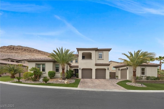 4220 San Alivia Ct, Las Vegas, NV 89141 - mediterranean / spanish-style home featuring driveway, stucco siding, an attached garage, and a tile roof