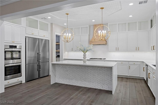4220 San Alivia Ct, Las Vegas, NV 89141 - kitchen featuring stainless steel appliances, a chandelier, custom range hood, open shelves, and backsplash
