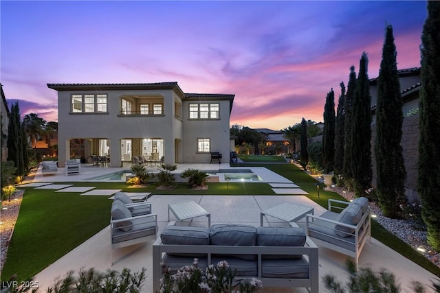 4220 San Alivia Ct, Las Vegas, NV 89141 - back of property at dusk featuring an outdoor living space, a patio, an outdoor pool, and stucco siding