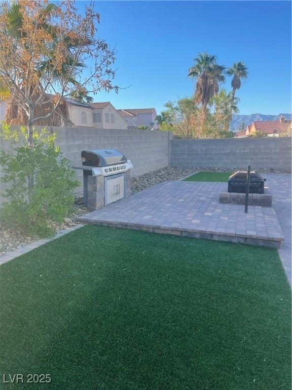 view of yard featuring a patio area and a fire pit