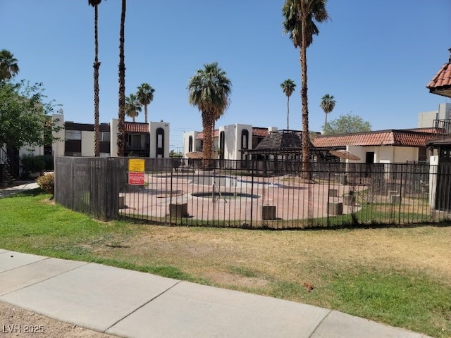 view of home's community featuring fence