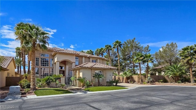 5445 Pendini Point Ct, Las Vegas, NV 89141 - mediterranean / spanish house featuring stucco siding, fence, a tiled roof, and a gate