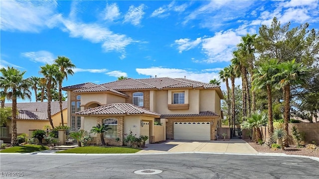 5445 Pendini Point Ct, Las Vegas, NV 89141 - mediterranean / spanish house with a tile roof, stucco siding, an attached garage, and driveway