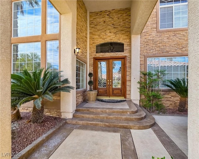 5445 Pendini Point Ct, Las Vegas, NV 89141 - view of exterior entry featuring french doors, stone siding, and stucco siding