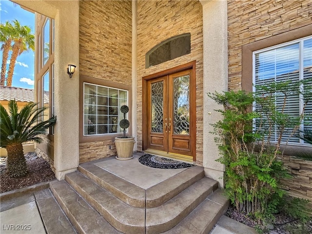 5445 Pendini Point Ct, Las Vegas, NV 89141 - doorway to property with french doors, stone siding, and stucco siding