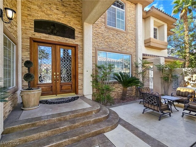 5445 Pendini Point Ct, Las Vegas, NV 89141 - entrance to property featuring french doors and stone siding
