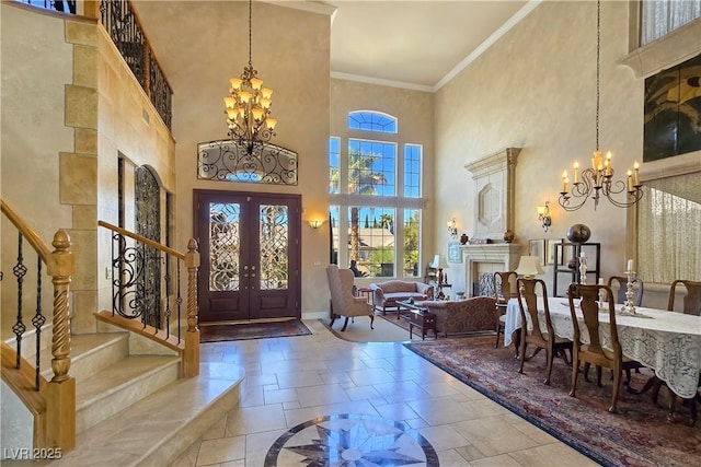 5445 Pendini Point Ct, Las Vegas, NV 89141 - entryway with a chandelier, a towering ceiling, french doors, stairs, and a fireplace