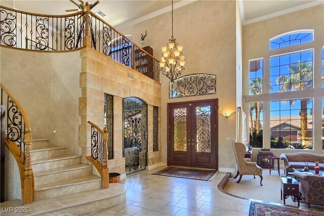 5445 Pendini Point Ct, Las Vegas, NV 89141 - entryway featuring a high ceiling, stairs, french doors, ornamental molding, and a chandelier
