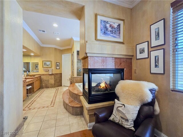 5445 Pendini Point Ct, Las Vegas, NV 89141 - sitting room with light tile patterned floors, crown molding, healthy amount of natural light, recessed lighting, and a tiled fireplace