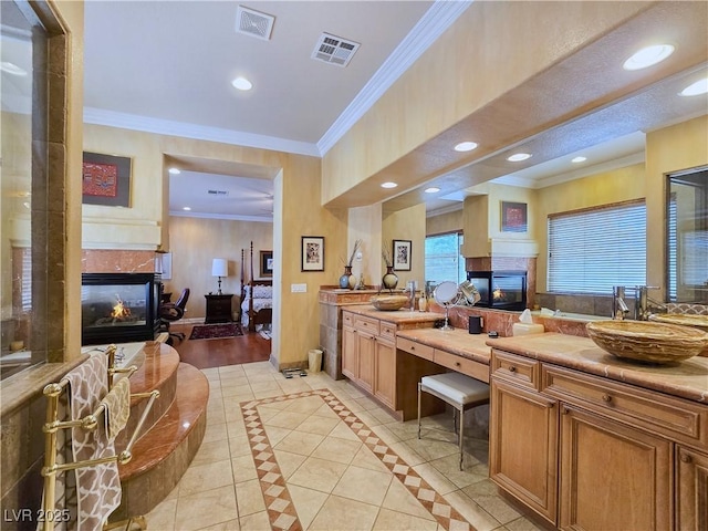 5445 Pendini Point Ct, Las Vegas, NV 89141 - full bathroom featuring a fireplace, double vanity, ensuite bathroom, recessed lighting, and crown molding