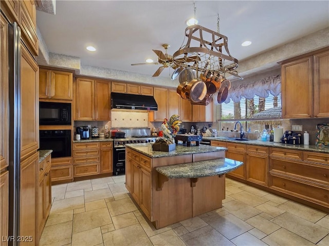5445 Pendini Point Ct, Las Vegas, NV 89141 - kitchen with under cabinet range hood, black appliances, a center island, decorative backsplash, and brown cabinetry