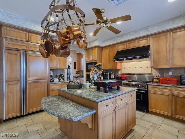 5445 Pendini Point Ct, Las Vegas, NV 89141 - kitchen with under cabinet range hood, built in appliances, backsplash, a center island, and a ceiling fan