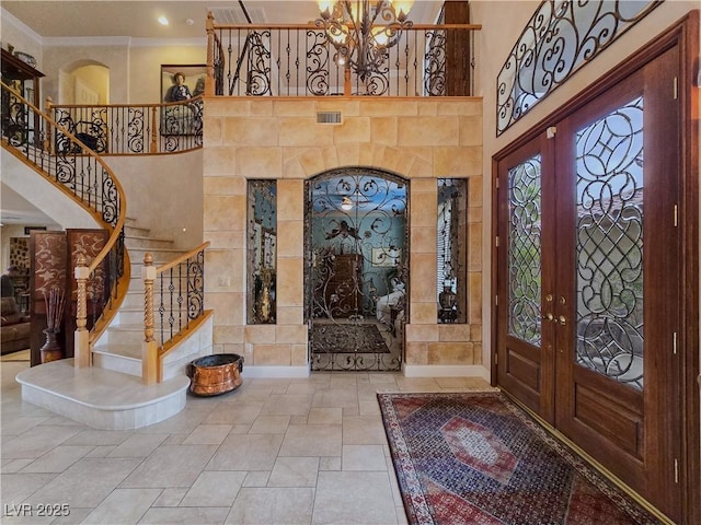 5445 Pendini Point Ct, Las Vegas, NV 89141 - entrance foyer featuring french doors, stairway, crown molding, a high ceiling, and a chandelier