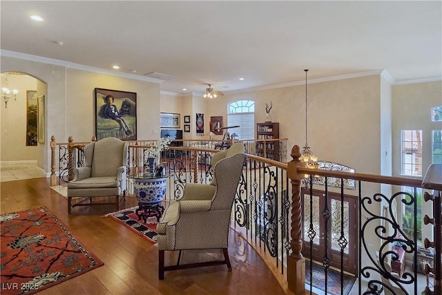 5445 Pendini Point Ct, Las Vegas, NV 89141 - living area with a chandelier, wood finished floors, arched walkways, recessed lighting, and ornamental molding