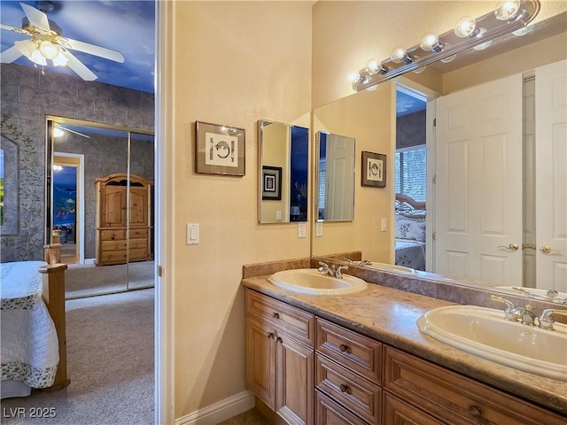 5445 Pendini Point Ct, Las Vegas, NV 89141 - bathroom featuring ensuite bath, double vanity, baseboards, and ceiling fan