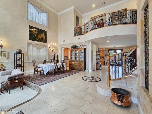 5445 Pendini Point Ct, Las Vegas, NV 89141 - foyer featuring a towering ceiling, a chandelier, crown molding, stairs, and stone tile floors