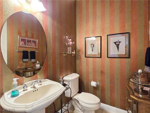 5445 Pendini Point Ct, Las Vegas, NV 89141 - half bathroom with a sink, toilet, and wallpapered walls