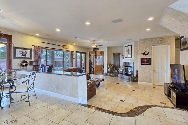5445 Pendini Point Ct, Las Vegas, NV 89141 - living room featuring recessed lighting, a ceiling fan, a high end fireplace, and baseboards