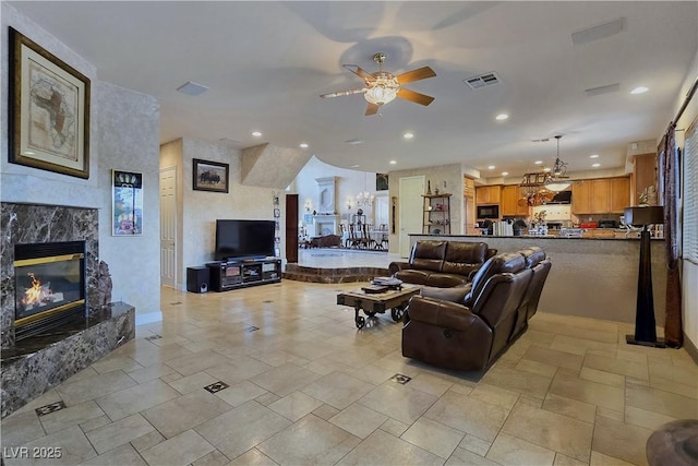 5445 Pendini Point Ct, Las Vegas, NV 89141 - living area with a ceiling fan, a premium fireplace, recessed lighting, and a chandelier