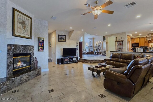 5445 Pendini Point Ct, Las Vegas, NV 89141 - living room featuring a ceiling fan, recessed lighting, a high end fireplace, and a chandelier