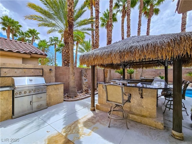 5445 Pendini Point Ct, Las Vegas, NV 89141 - view of patio / terrace featuring area for grilling, a fenced backyard, and a bar