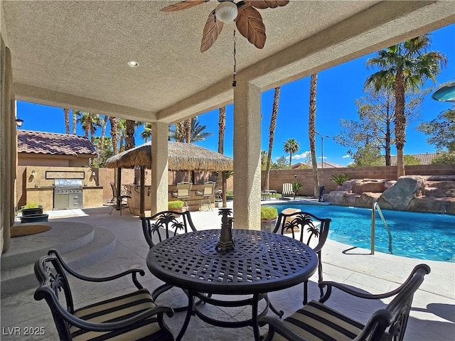 5445 Pendini Point Ct, Las Vegas, NV 89141 - view of patio with a fenced backyard, grilling area, an outdoor kitchen, and ceiling fan