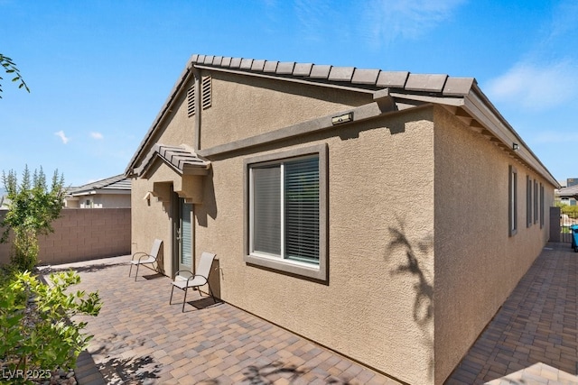 3709 Neblina Dr, Henderson, NV 89052 - view of property exterior featuring stucco siding, a patio area, and fence