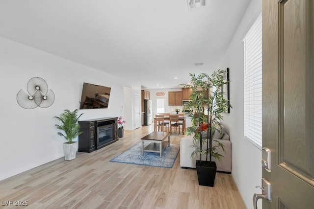 3709 Neblina Dr, Henderson, NV 89052 - living room with light wood-style flooring, a glass covered fireplace, baseboards, and recessed lighting