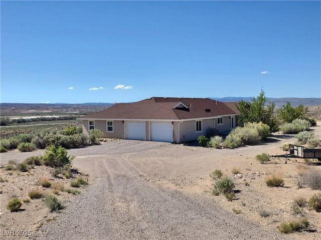 5272 Truman Ln, Caliente, NV 89008 - view of front facade with a garage and dirt driveway