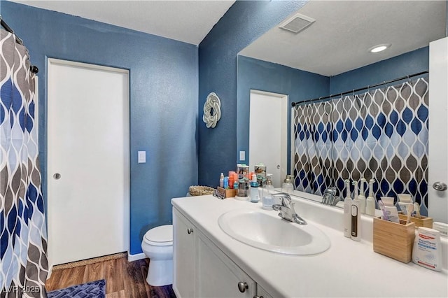 9065 Adorable Ave, Las Vegas, NV 89149 - bathroom featuring toilet, vanity, wood finished floors, a textured wall, and baseboards