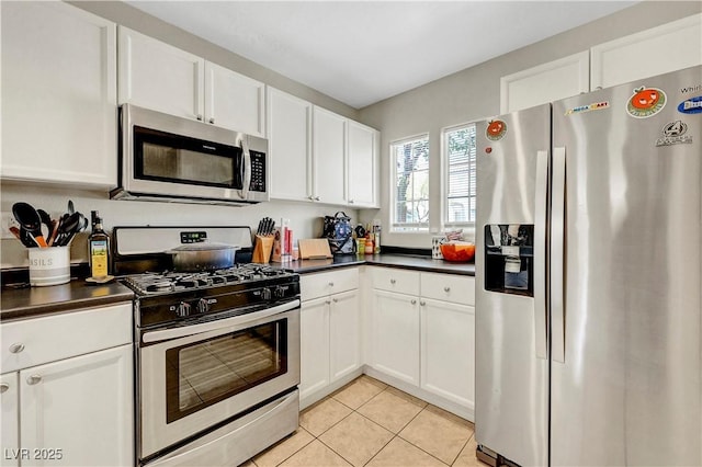 9065 Adorable Ave, Las Vegas, NV 89149 - kitchen with stainless steel appliances, dark countertops, and white cabinets