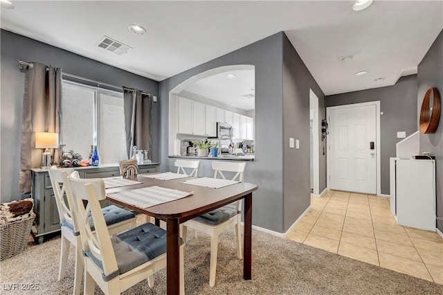 9065 Adorable Ave, Las Vegas, NV 89149 - dining space with arched walkways, recessed lighting, light tile patterned floors, light colored carpet, and baseboards