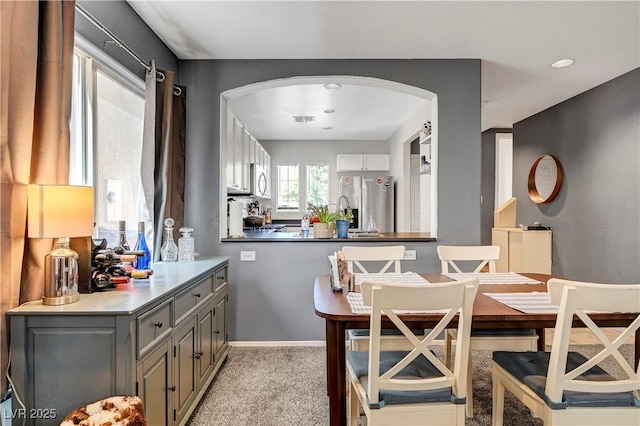 9065 Adorable Ave, Las Vegas, NV 89149 - dining area featuring arched walkways, light colored carpet, and baseboards