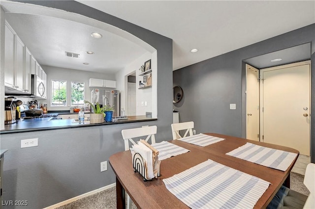 9065 Adorable Ave, Las Vegas, NV 89149 - carpeted dining area with arched walkways and recessed lighting