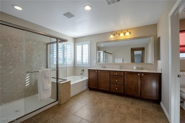 7520 Fontera Ct, Las Vegas, NV 89139 - full bath featuring toilet, a bath, a stall shower, double vanity, and tile patterned flooring
