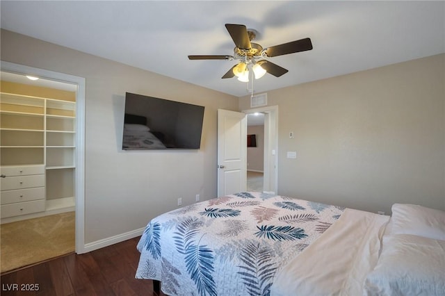 7520 Fontera Ct, Las Vegas, NV 89139 - bedroom with a spacious closet, wood finished floors, a closet, ceiling fan, and baseboards