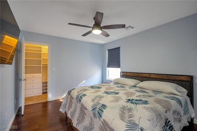 7520 Fontera Ct, Las Vegas, NV 89139 - bedroom with wood finished floors, a spacious closet, baseboards, ceiling fan, and a closet