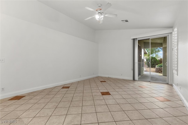 spare room with lofted ceiling, light tile patterned flooring, ceiling fan, and baseboards