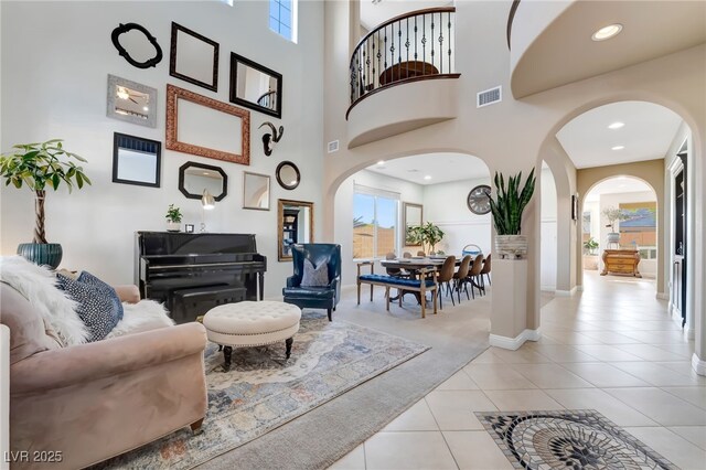 7778 Villa Montara St, Las Vegas, NV 89123 - living area featuring arched walkways, light tile patterned flooring, baseboards, a high ceiling, and recessed lighting