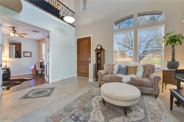 7778 Villa Montara St, Las Vegas, NV 89123 - living room with tile patterned floors, ceiling fan, baseboards, and a high ceiling