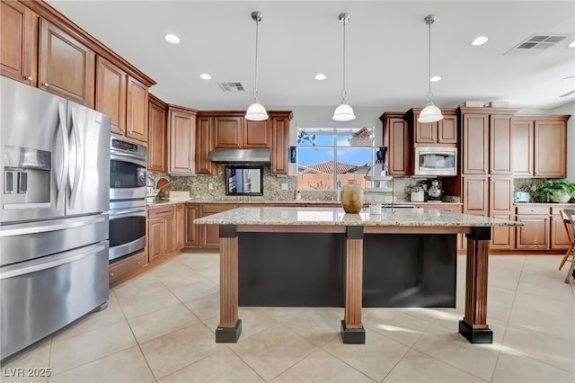 7778 Villa Montara St, Las Vegas, NV 89123 - kitchen featuring stainless steel appliances, under cabinet range hood, a breakfast bar area, a center island, and decorative backsplash