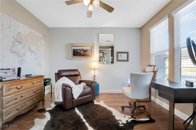 7778 Villa Montara St, Las Vegas, NV 89123 - living area with an office area, a ceiling fan, wood finished floors, and baseboards