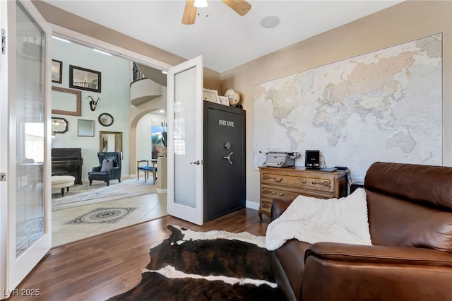 7778 Villa Montara St, Las Vegas, NV 89123 - living area featuring a ceiling fan, arched walkways, and wood finished floors