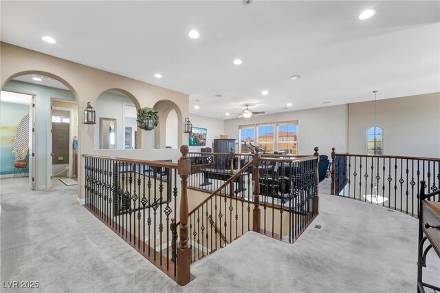 7778 Villa Montara St, Las Vegas, NV 89123 - corridor with carpet floors, an upstairs landing, recessed lighting, arched walkways, and baseboards