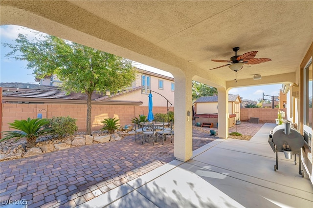 7778 Villa Montara St, Las Vegas, NV 89123 - view of patio with a hot tub, a fenced backyard, ceiling fan, and outdoor dining area