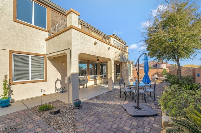 7778 Villa Montara St, Las Vegas, NV 89123 - view of patio with a balcony, a ceiling fan, fence, and outdoor dining area