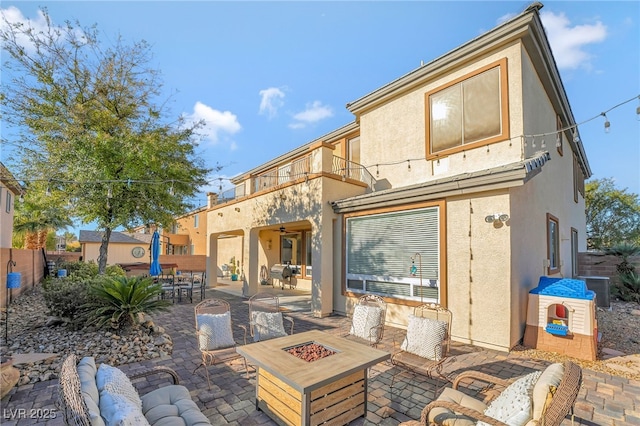 7778 Villa Montara St, Las Vegas, NV 89123 - back of house featuring stucco siding, a balcony, a patio, a fire pit, and central AC unit