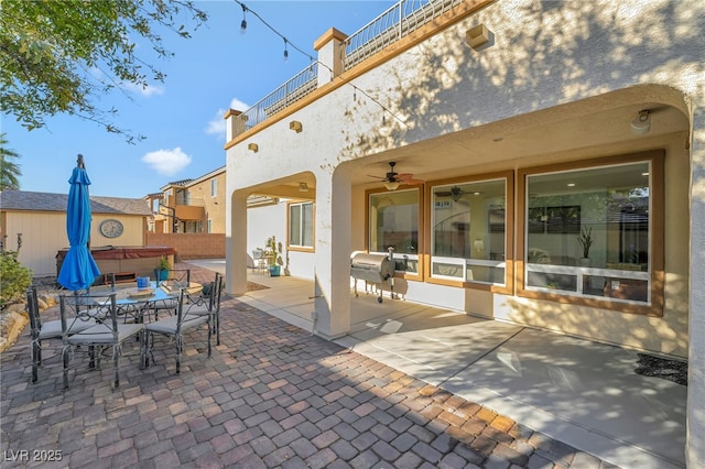 7778 Villa Montara St, Las Vegas, NV 89123 - view of patio featuring a hot tub, outdoor dining space, ceiling fan, and fence