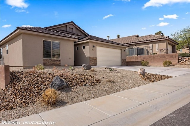 942 Shadow Hawk Rdg, Mesquite, NV 89027 - single story home with concrete driveway, a garage, stucco siding, and stone siding
